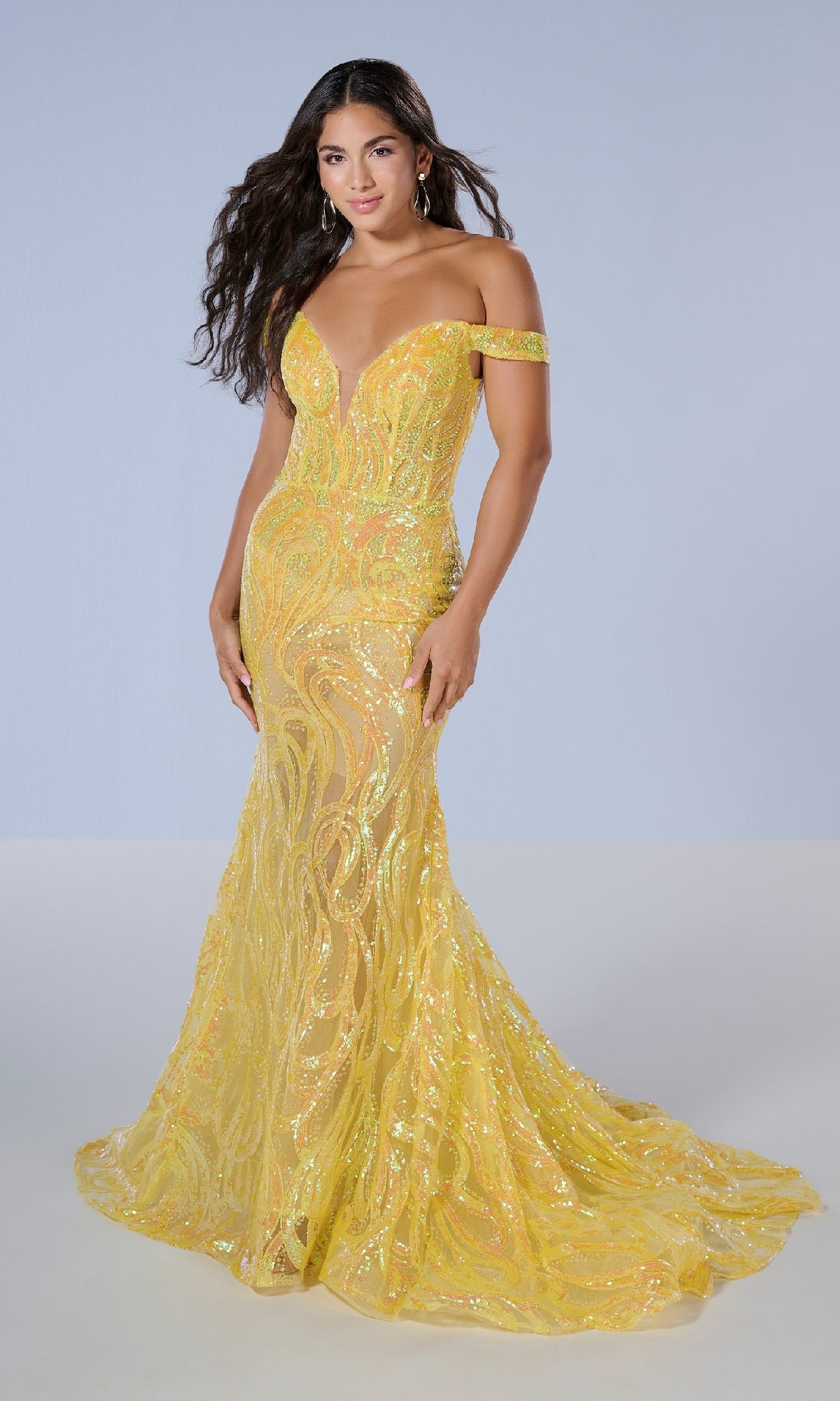 A woman models the Tiffany 16224 long prom dress—an off-the-shoulder, floor-length yellow sequin gown with a fitted mermaid silhouette and deep V neckline—against a plain light background.